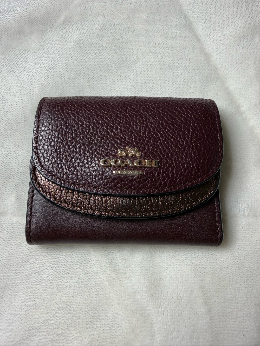 Coach Pebbled Leather Compact Wallet in Deep Burgundy with Metallic Accent
